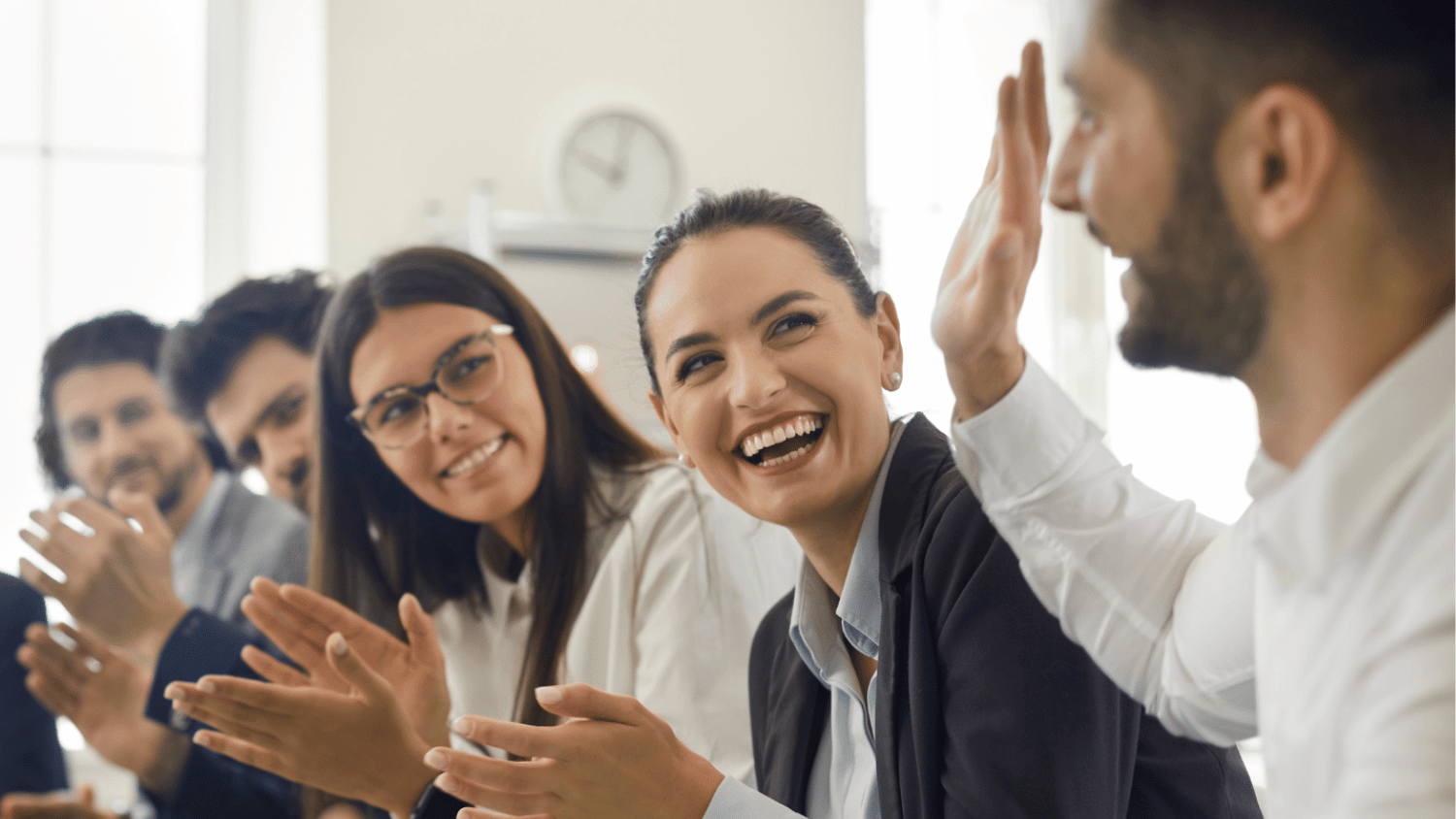 Staff applauding a fellow staff member.
